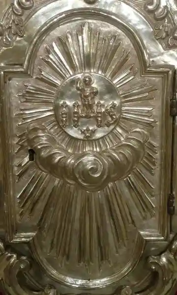 Baby Jesus on top of IHS and in the middle of sun symbol